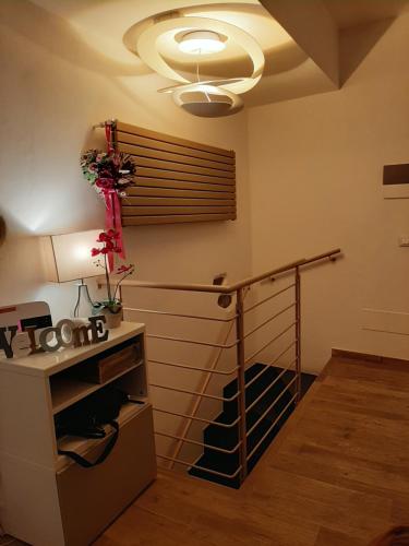 a room with a staircase with a table and a lamp at Pepita di Rio in Riomaggiore