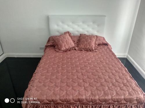 a bed with two pillows on it in a bedroom at Vista Angular in Tandil