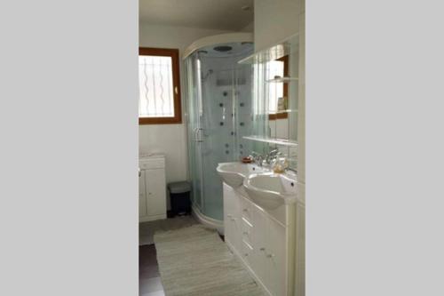 a bathroom with a sink and a shower at Chalet Loulou, massif central, Le Mont-Dore in Le Mont-Dore