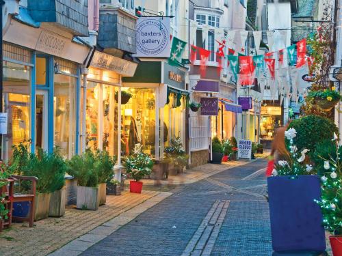 a street in a city with shops and flags at 201 Norton Park in Dartmouth