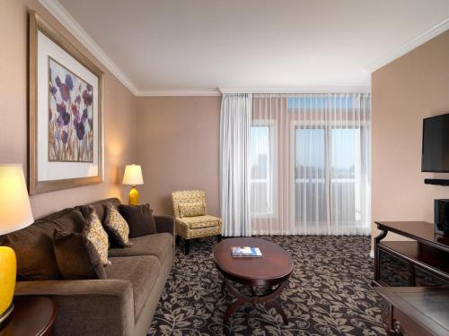 a living room with a couch and a table at Hotel Grand Pacific in Victoria