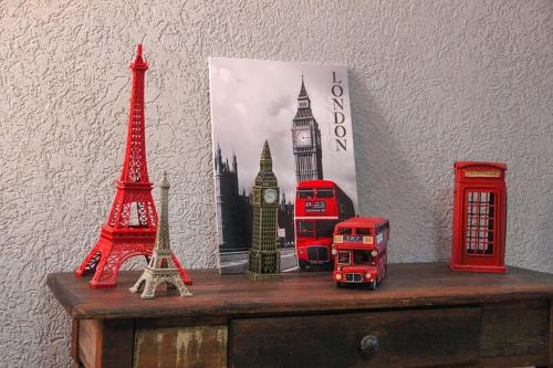 a table with red double decker buses on it at Casa Rebello - Pousada in Itajaí