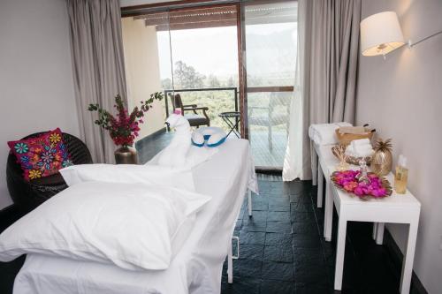 a hotel room with two beds and a window at Empedrada Ranch & Lodge - Hotel Asociado Casa Andina in Caral