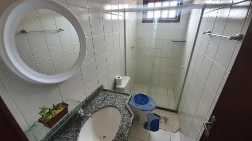 a bathroom with a sink and a mirror and a toilet at Gravatá Country House in Gravatá
