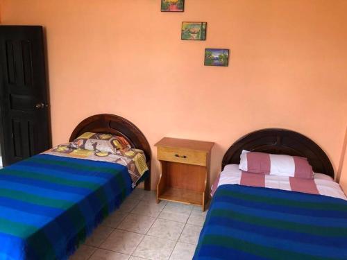a bedroom with two beds and a night stand at Zumag Sisa in Tena