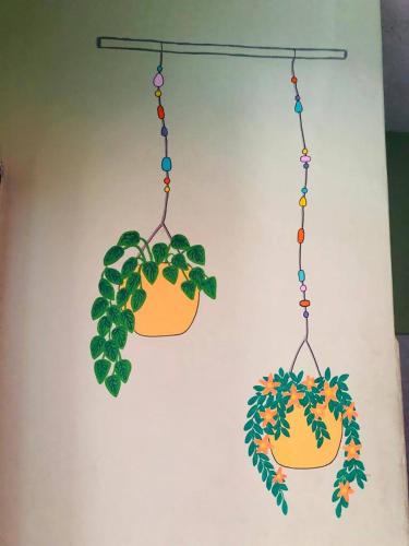 two potted plants hanging on a wall at Zumag Sisa in Tena
