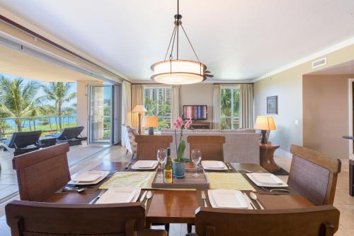 a dining room with a table and chairs at Honua kai - Konea 301 Frontline with BBQ! in Kaanapali