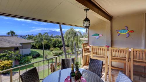 a patio with a table and chairs on a balcony at Maui Eldorado - D206 in Lahaina