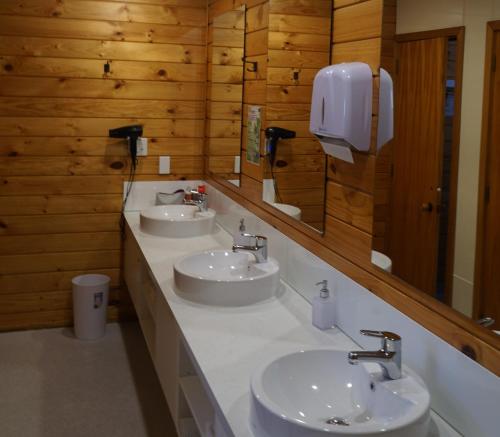 
a bathroom with two sinks and a mirror at Altamont Lodge in Wanaka
