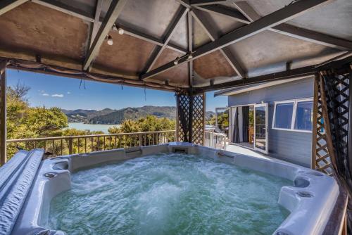 a hot tub on the balcony of a house at Harbour View in Whangaroa