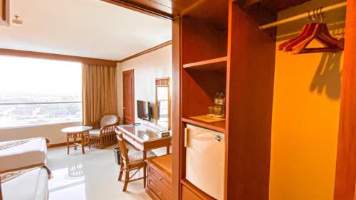 a room with a kitchen and a dining room at K Park Grand Hotel in Surat Thani