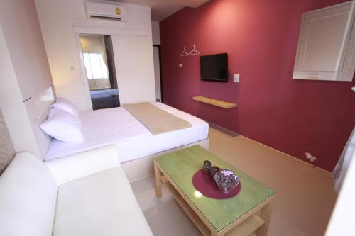 a small room with two beds and a table at Bearing26 Hotel in Bangna