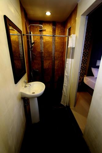 a bathroom with a sink and a shower at Bearing26 Hotel in Bangna