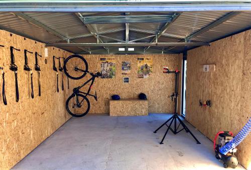 a room with a bike hanging on the wall at Hotel Finca Aldabra in Pinos Genil