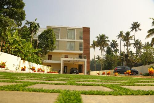 a building with a car parked in front of it at Riverside Inn Homestay in Cochin