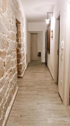 an empty hallway with a brick wall and a hallway sidx sidx at viche viche in Orgosolo