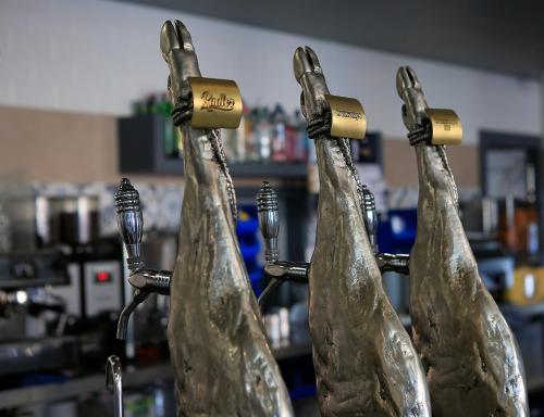 a group of four wine bottles with their necks up at Hotel Leo in Monesterio