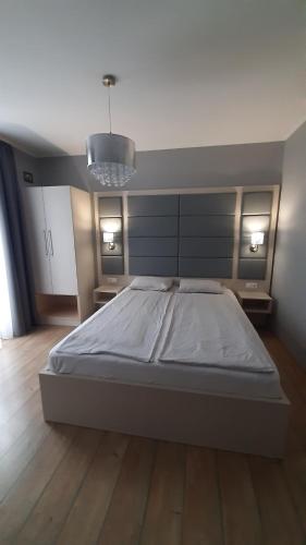 a large bed in a room with a large bed sidx sidx sidx at 4 ÁSZ Deluxe Apartman in Gyula