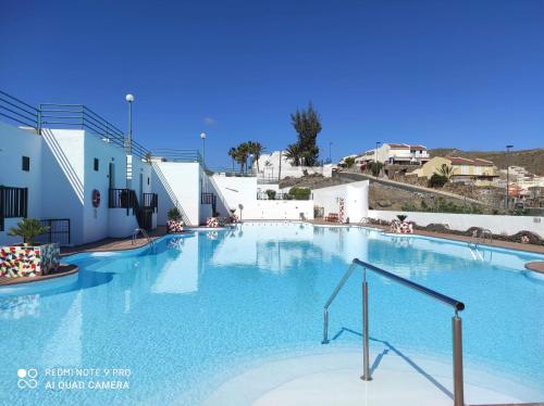 a large blue swimming pool in a building at La Sabina in Mogán