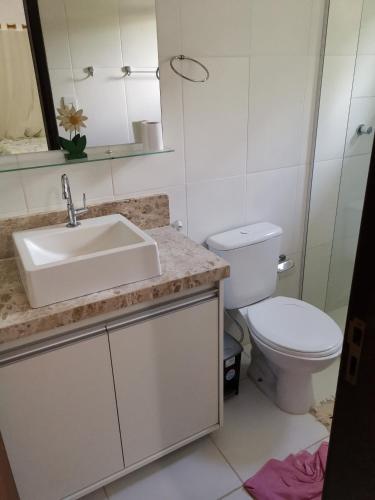 a bathroom with a sink and a toilet at Recanto do Angelo in Praia do Forte