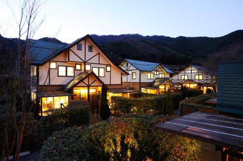 a row of houses with their lights on at night at Lake Villa Kawaguchiko in Fujikawaguchiko