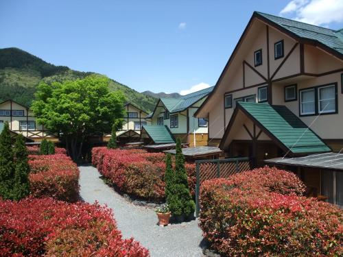 a row of houses with flowers in front of them at Lake Villa Kawaguchiko in Fujikawaguchiko
