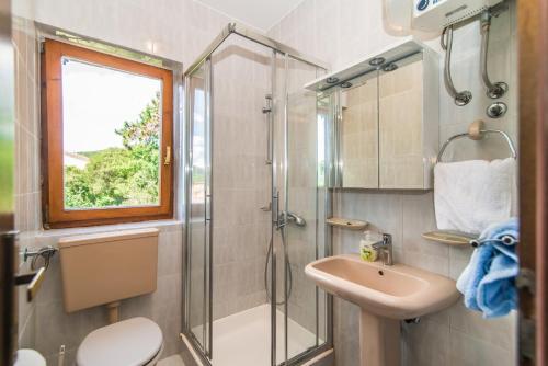 a bathroom with a shower and a sink at Apartments Pino Rabac in Rabac