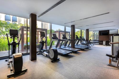 a gym with rows of treadmills and elliptical machines at InterContinental Dhaka by IHG in Dhaka