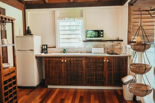 a kitchen with a sink and a refrigerator at Domaine Saint-François in Saint-François