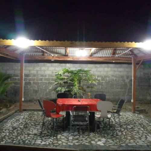 a table and chairs in a patio at night at Remarkable 4-Bed with air conditioning in Brikama in Brikama