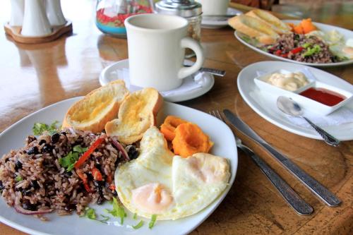 a plate of food with eggs and rice on a table at Bella Vista Corcovado in Drake