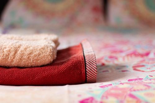 a red towel sitting on top of a bed at Op d'n Stolberg in Weert