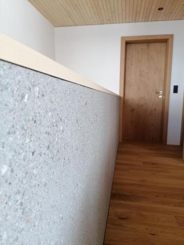 a room with a concrete wall and a door at Kanis 80 in Schnepfau