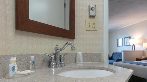 a bathroom with a sink and a mirror at Comfort Inn Boardwalk in Ocean City