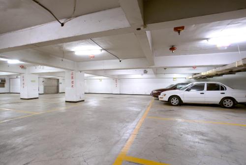 a parking garage with a white car parked in it at Ever Luck Hotel in Kaohsiung