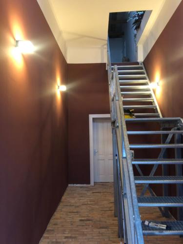 a staircase in a room with a door and lights at Spinnerei in Spechtholzhock