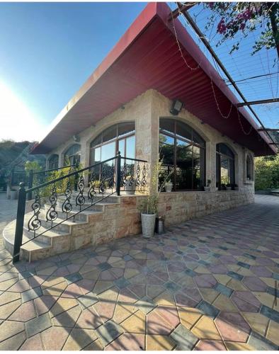 a building with a staircase in front of a building at استراحة المعمورة Al maamoura Retreat in Hatta