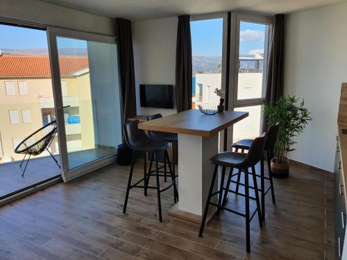 a room with a table and chairs and a balcony at Grand Palace in Trogir