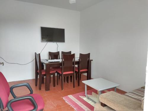 a living room with a dining room table and chairs at Nascer do Bosque in Cabo Frio