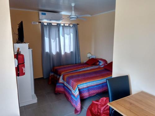 a bedroom with a bed and a window and a table at Colon M in Colón