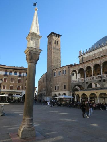 a street light in a square with a clock tower at Foresteria Conti, sulle tracce di Shakespeare in Padova