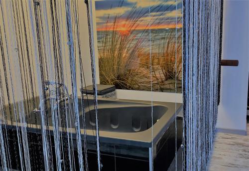 a bath tub in a room with a view of the ocean at Apartament z tarasem in Wisełka