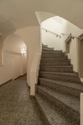 a staircase in an empty building with a stair case at Lovely Flat in a Lovely City in Steyr