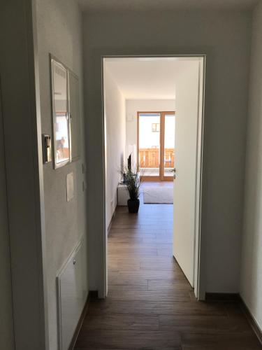 an empty hallway with a door leading to a room at Apartment Berg und See in Schliersee