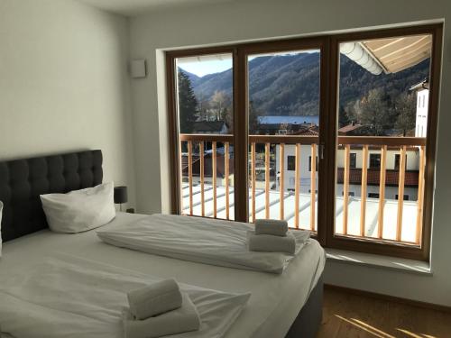 a bedroom with a bed and a large window at Apartment Berg und See in Schliersee