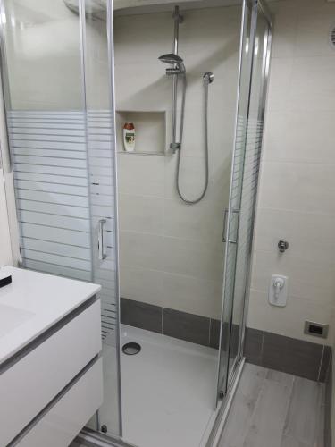 a shower with a glass door in a bathroom at residence San miniato in Loro Ciuffenna
