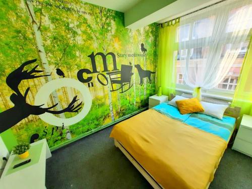 ポズナンにあるCOLOR Hostelのベッドルーム1室(木の壁画のあるベッド1台付)
