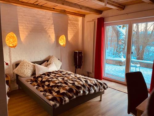 a bedroom with a bed and a large window at Riverside apartment in central Herzogenaurach in Herzogenaurach