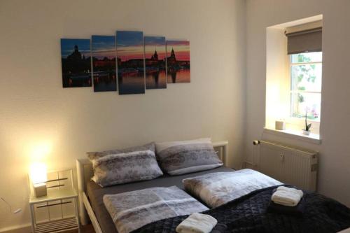 a bedroom with two beds and a painting on the wall at Zentralgelegene 4-Raum Ferienwohnung bis 8 Pers. in Dresden