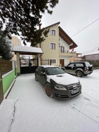 a car parked in a driveway covered in snow at Guesthouse Tershana in Peshkopi